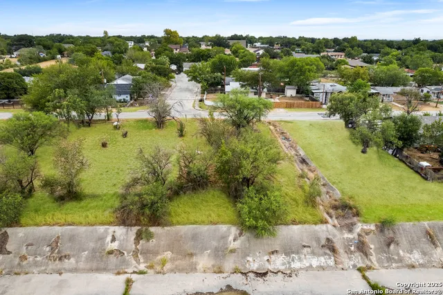 an aerial view of a house with a yard