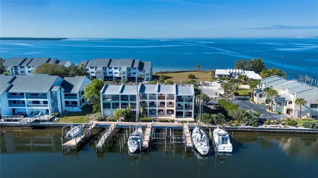 a view of a lake from a balcony with furniture