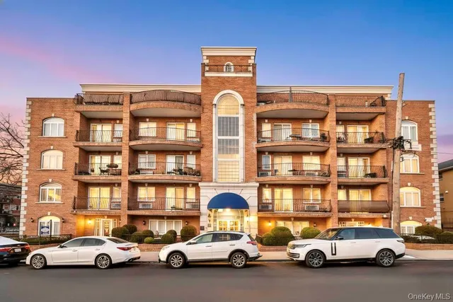 a view of a cars park in front of a building