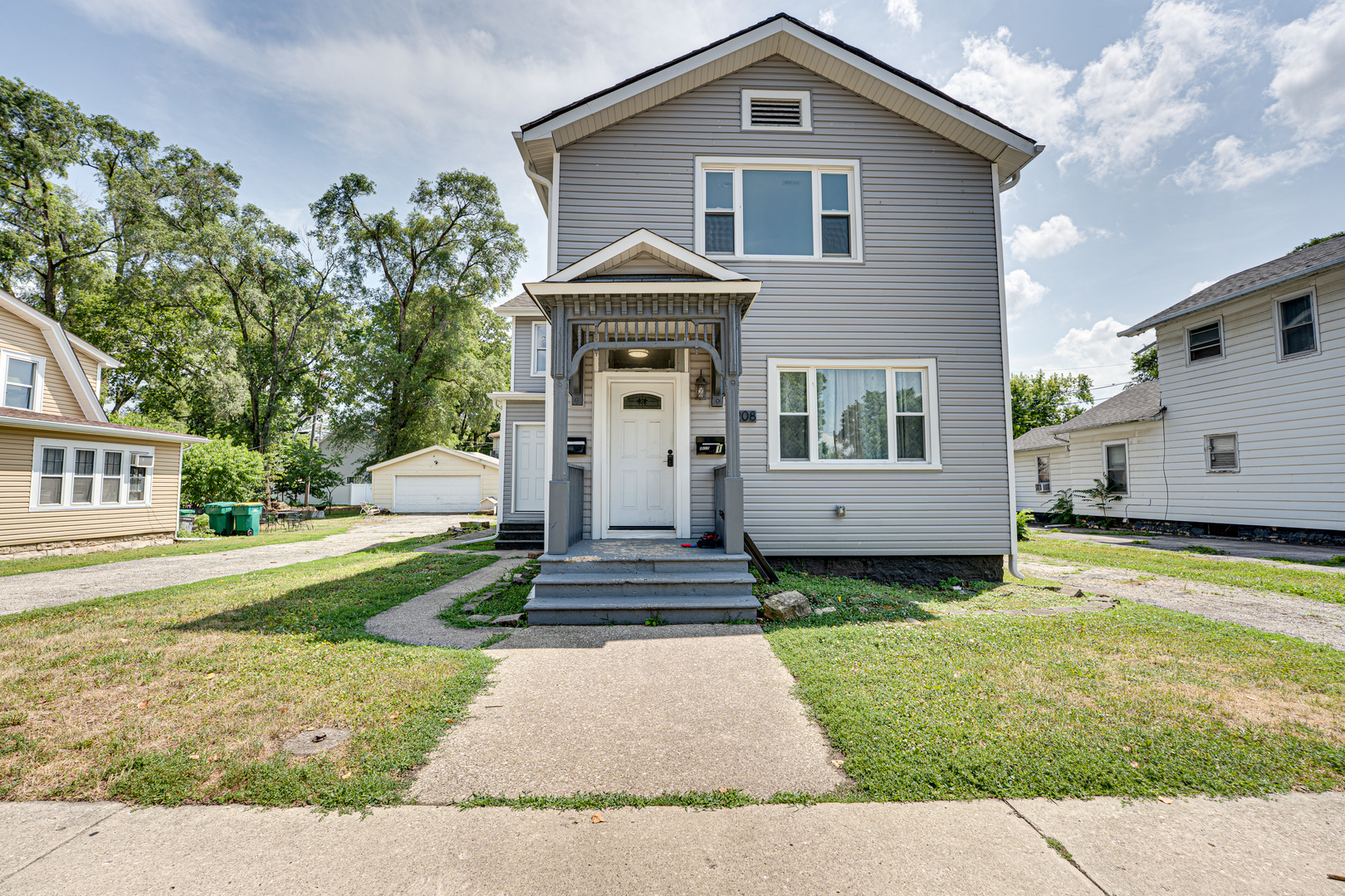208 Mound Street, Unit 2 Joliet, IL 60433 - Photo 1 of 18 a front view of a house with garden