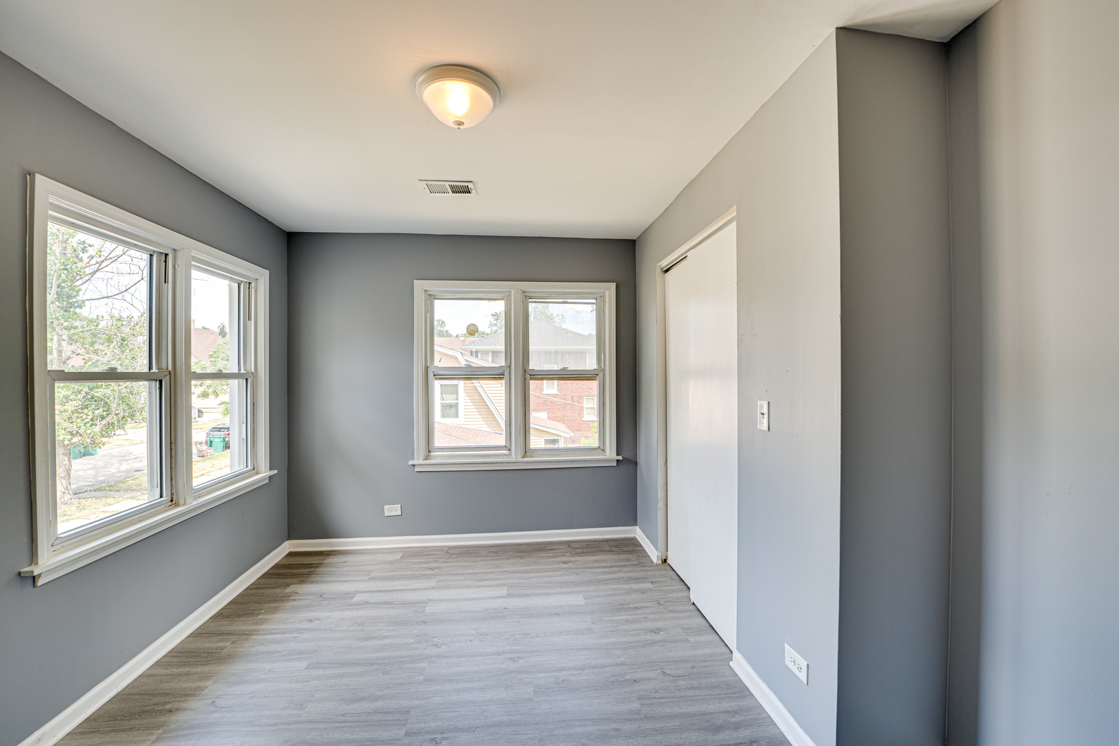 208 Mound Street, Unit 2 Joliet, IL 60433 - Photo 11 of 18 a view of an empty room with wooden floor and a window