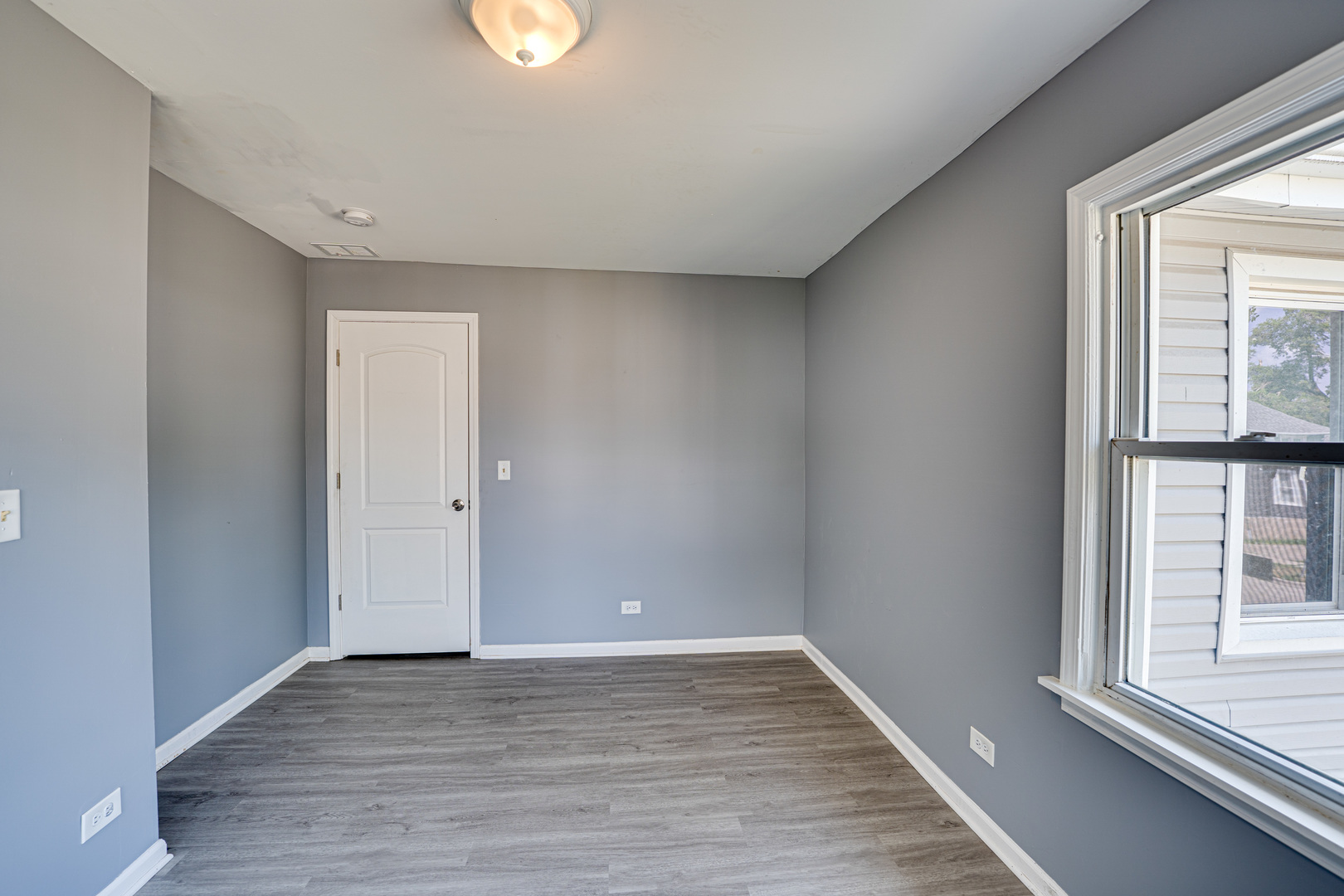 208 Mound Street, Unit 2 Joliet, IL 60433 - Photo 12 of 18 wooden floor in an empty room with a window