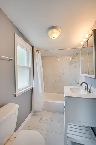 a bathroom with a bathtub and a sink