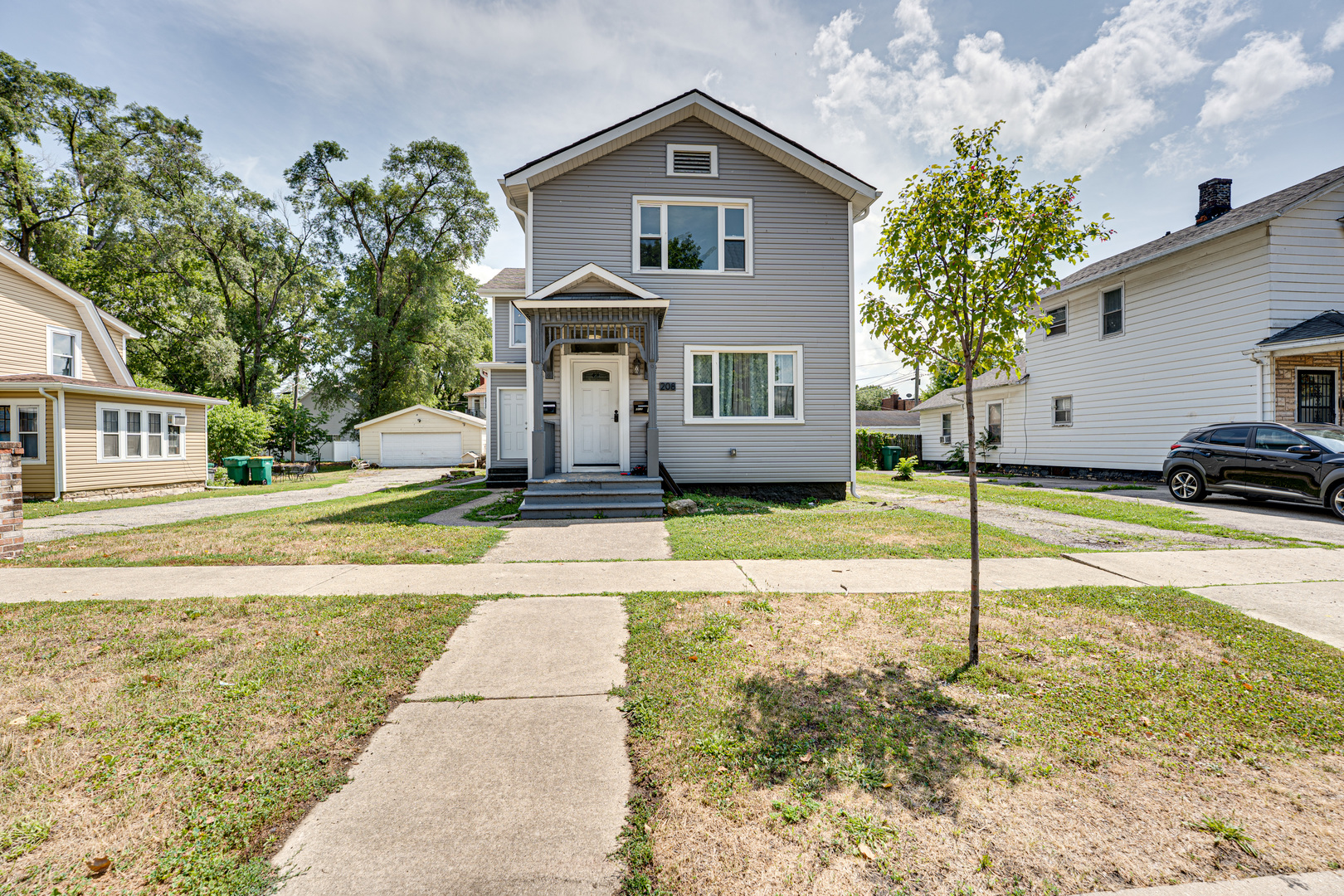 208 Mound Street, Unit 2 Joliet, IL 60433 - Photo 2 of 18 a front view of a house with a yard