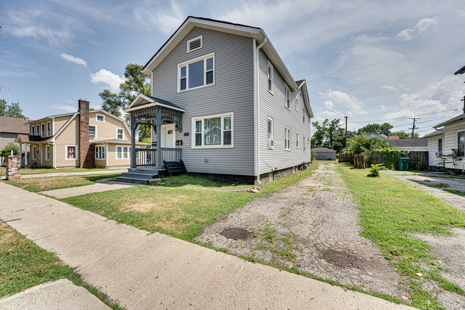 208 Mound Street, Unit 2 Joliet, IL 60433 - Photo 3 of 18 a front view of a house with a garden