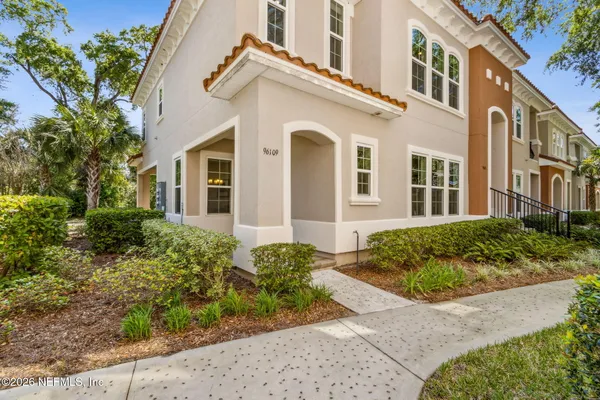 front view of a brick house with a yard