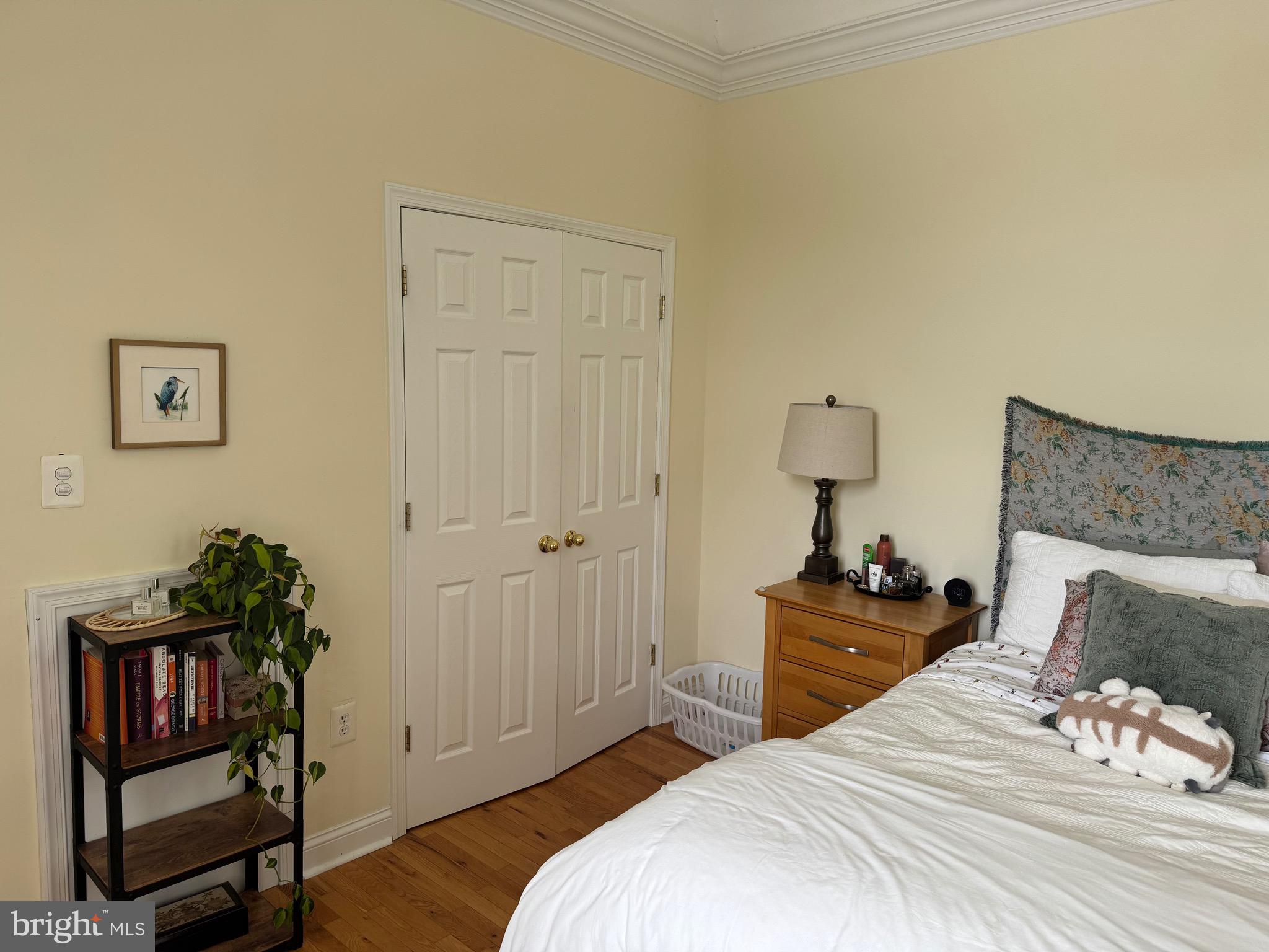 1 Kings Court, Unit 5 Haddonfield, NJ 08033 - Photo 6 of 15 a bedroom with a bed and wooden floor