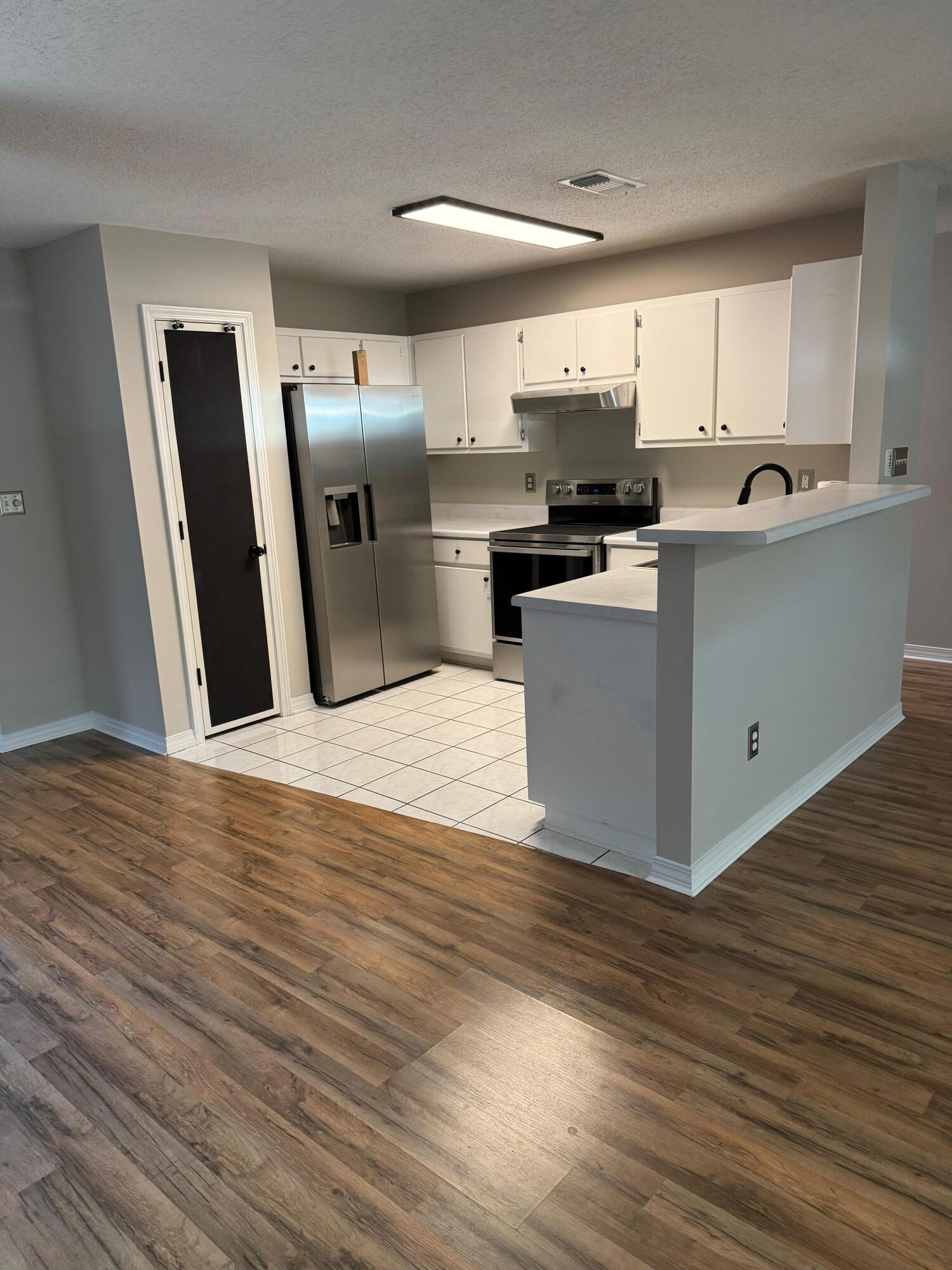 38 Ruby Circle Mary Esther, FL 32569 - Photo 12 of 50 a kitchen with stainless steel appliances granite countertop a refrigerator and a stove top oven