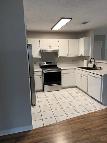 a view of a livingroom with wooden floor and a ceiling fan