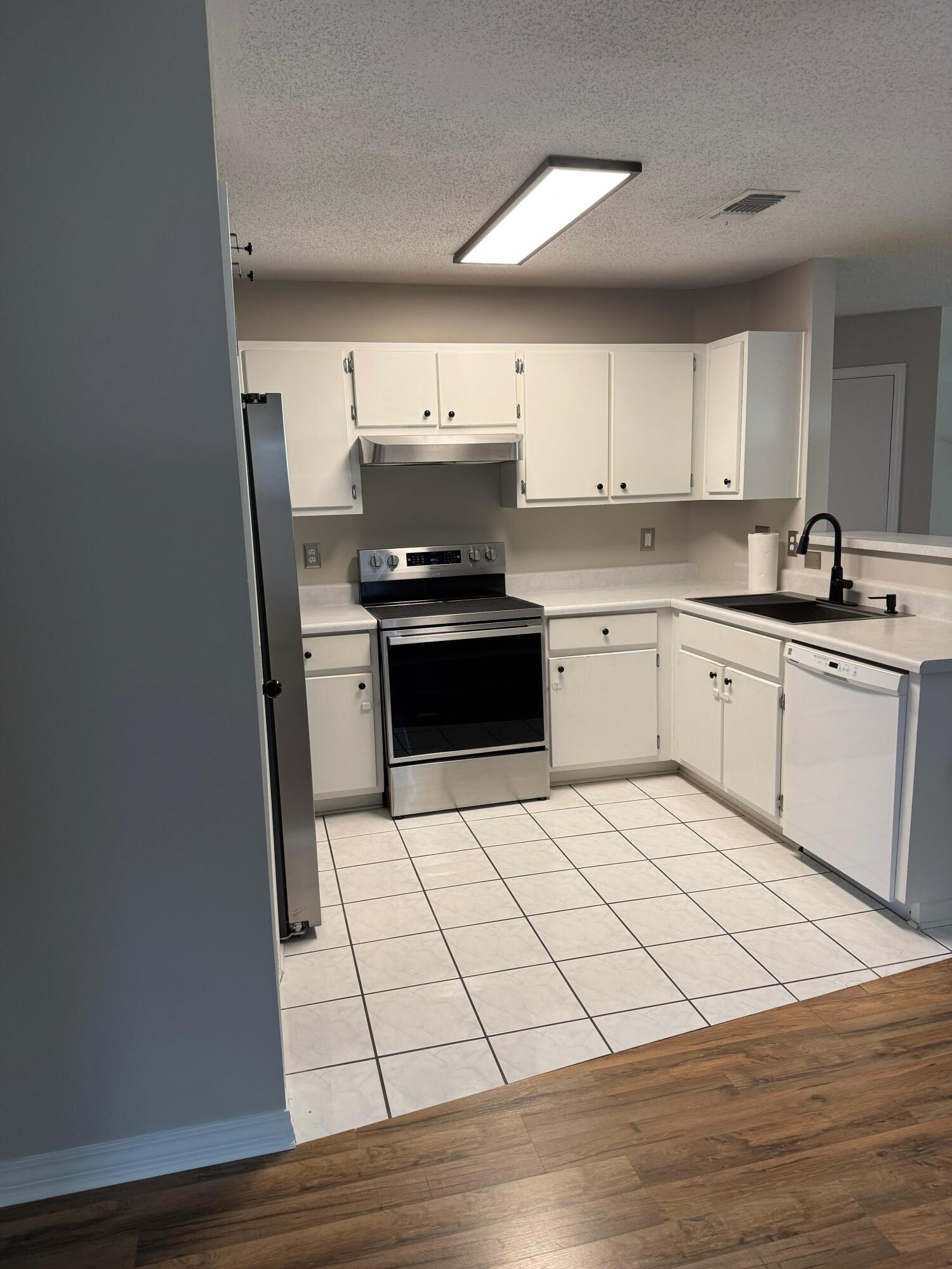 38 Ruby Circle Mary Esther, FL 32569 - Photo 14 of 50 a kitchen with a sink a stove and white cabinets