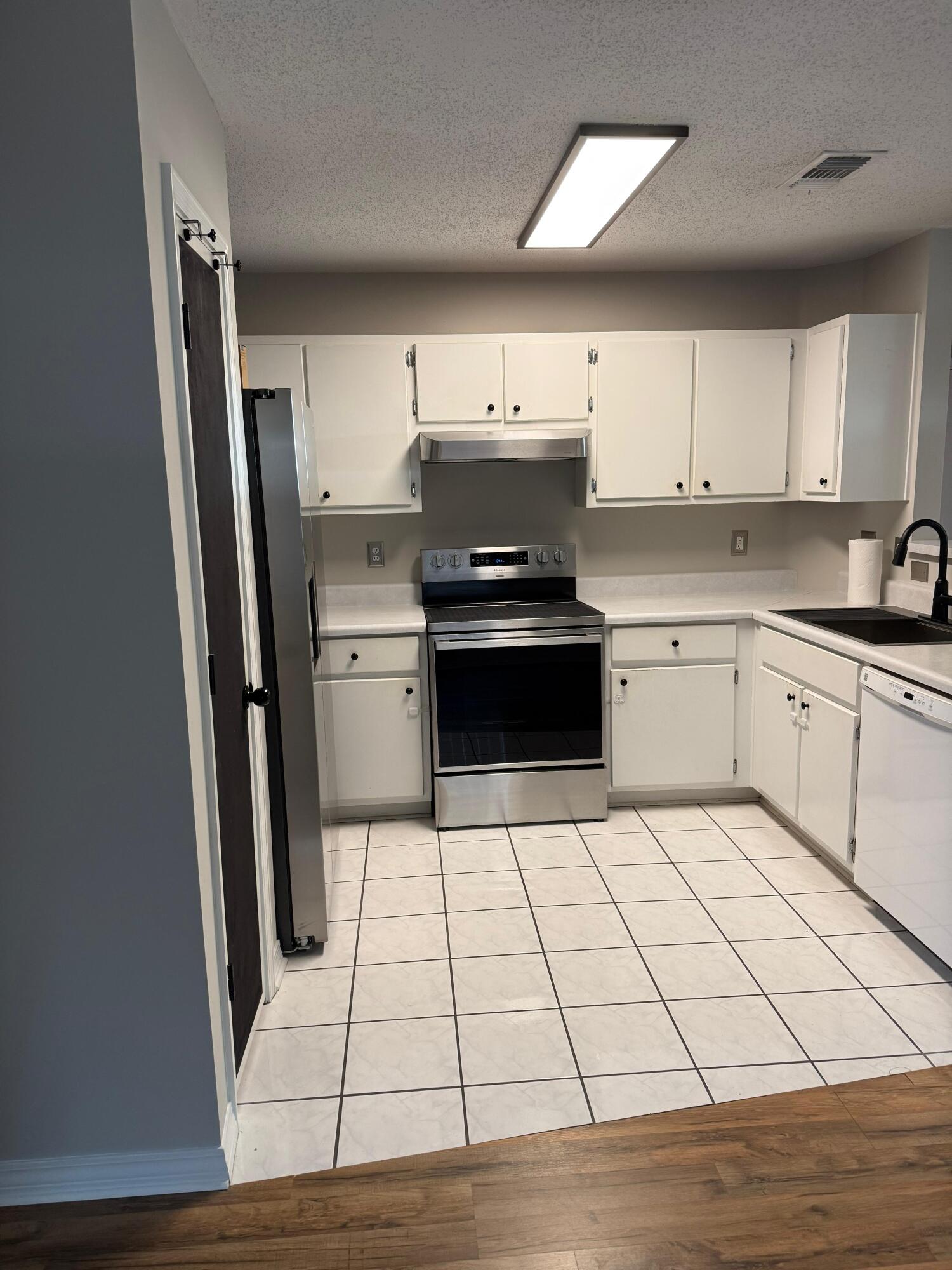 38 Ruby Circle Mary Esther, FL 32569 - Photo 17 of 50 a kitchen with stainless steel appliances a refrigerator sink and cabinets