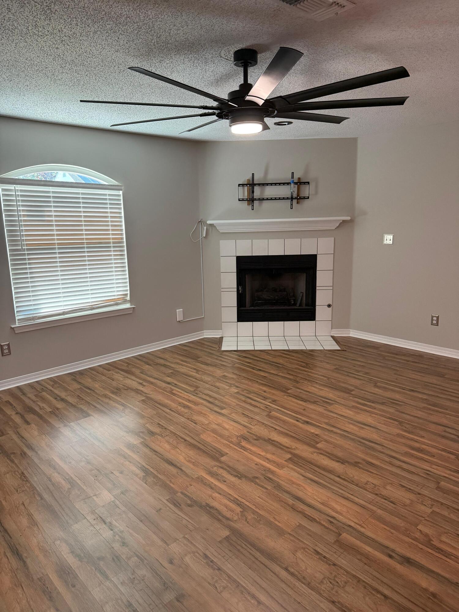 38 Ruby Circle Mary Esther, FL 32569 - Photo 24 of 50 an empty room with wooden floor a ceiling fan and windows