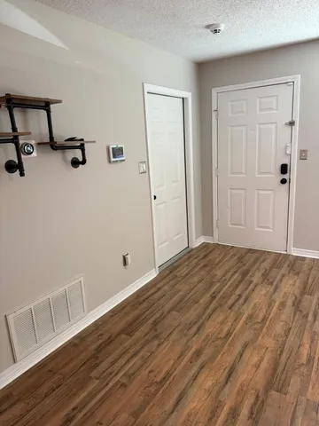 a view of a hallway with wooden floor