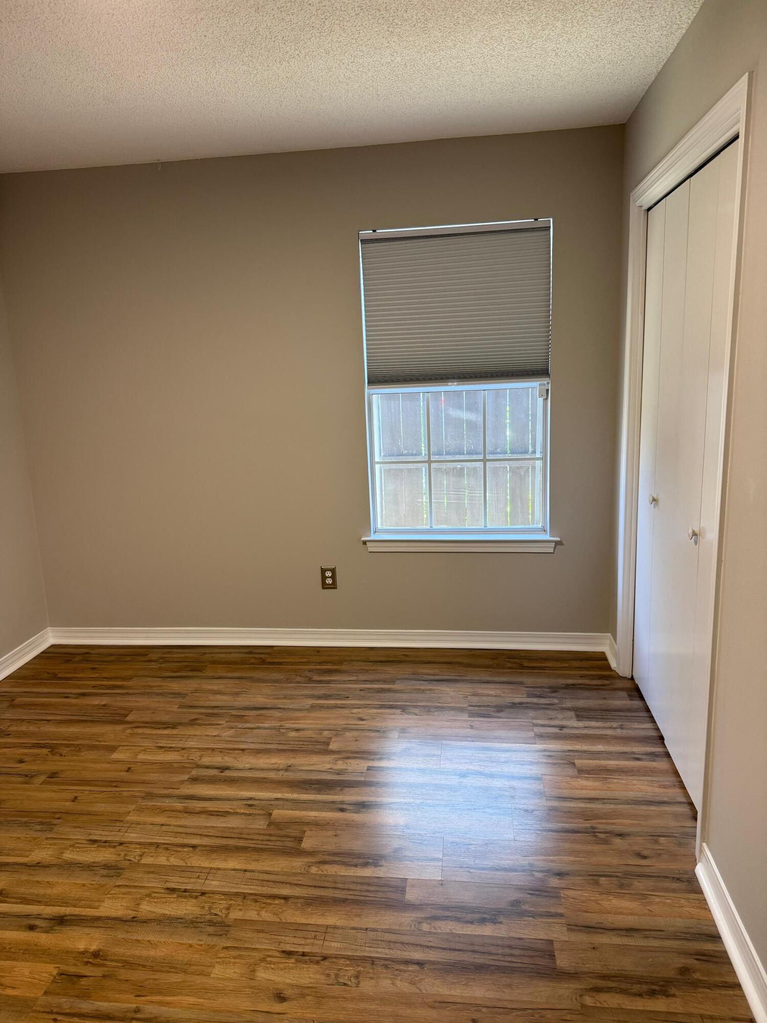 38 Ruby Circle Mary Esther, FL 32569 - Photo 42 of 50 a view of an empty room with wooden floor and a window