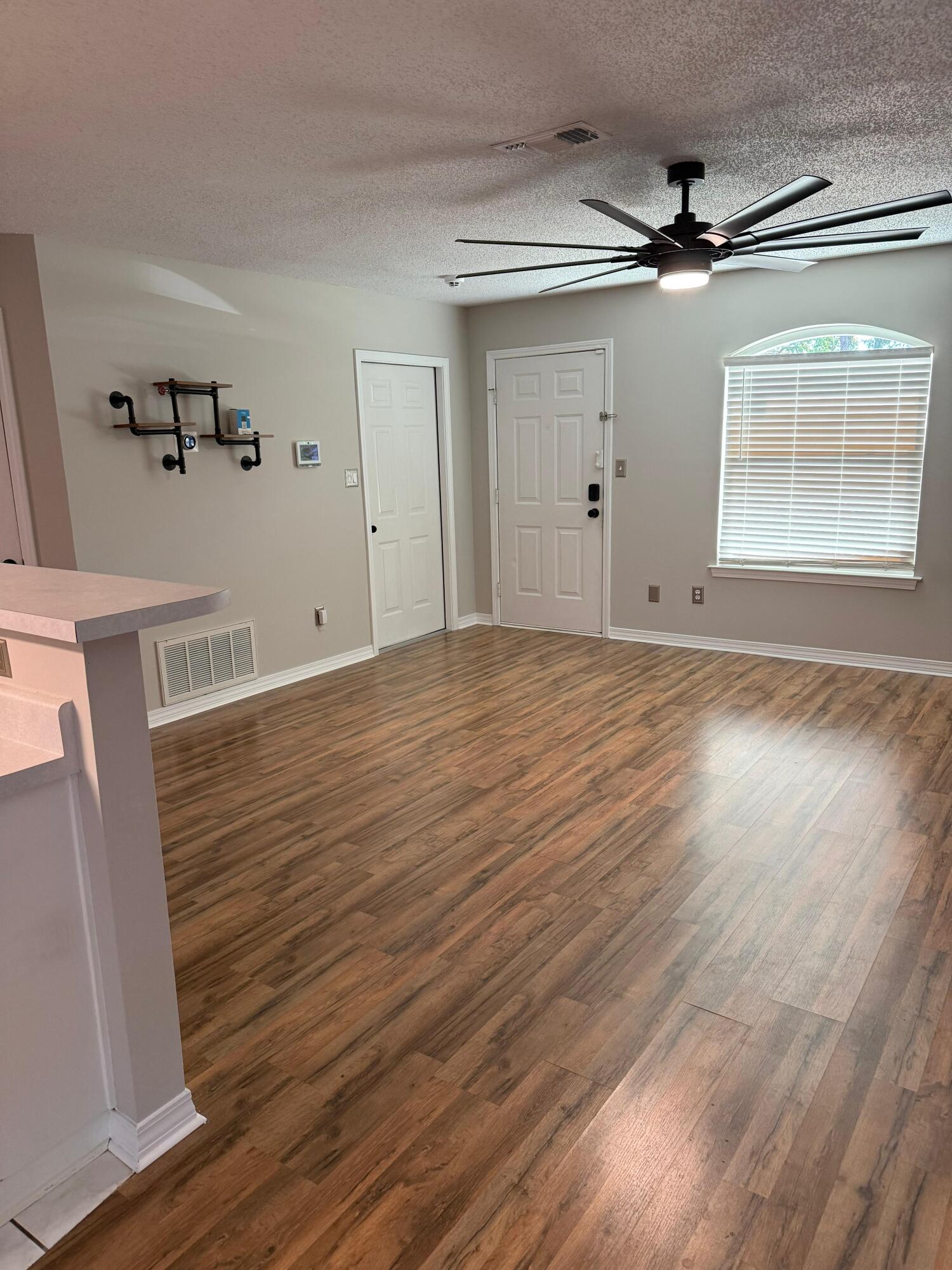 38 Ruby Circle Mary Esther, FL 32569 - Photo 10 of 50 a view of empty room with wooden floor and fan