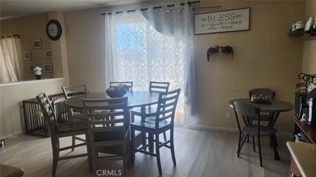 a view of a dining room with furniture and wooden floor