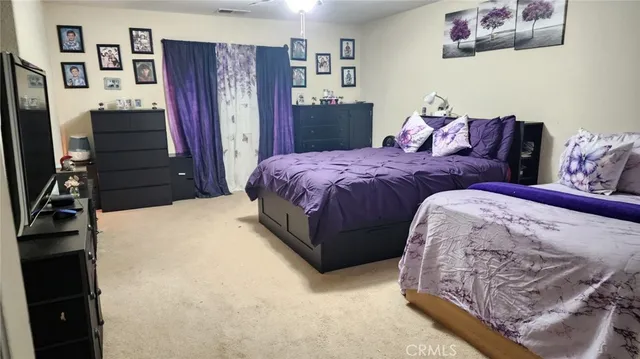 a bedroom with bed and wooden floor