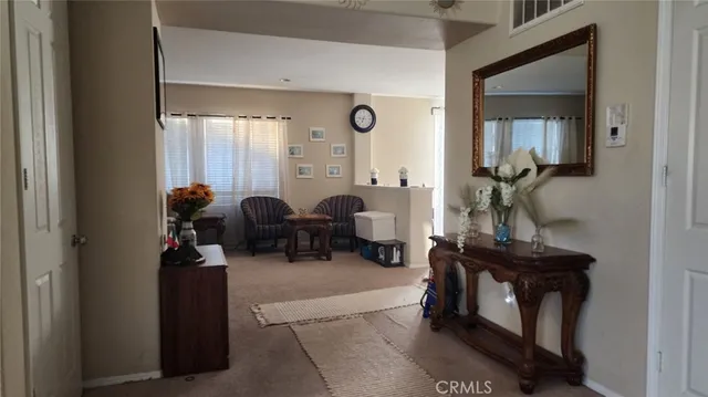 a living room with furniture and a mirror
