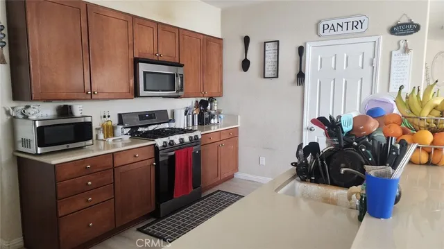 a kitchen with stainless steel appliances granite countertop a sink stove and microwave