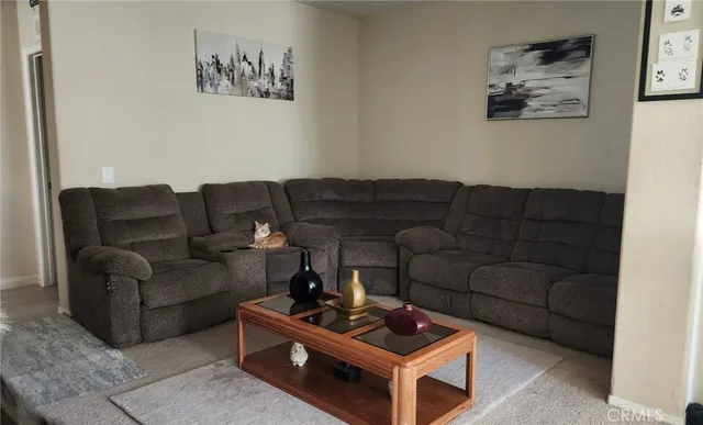 a living room with furniture a couch and a window