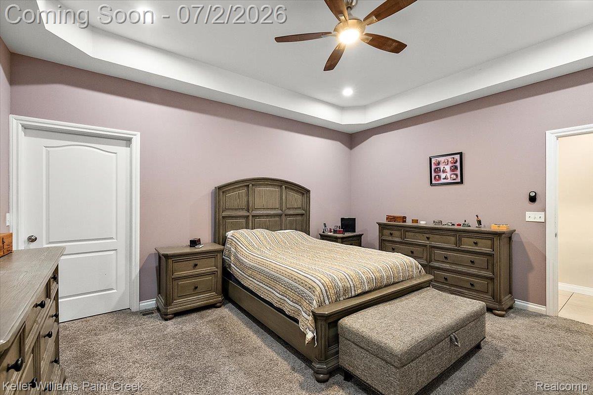 54230 Card Road Macomb, MI 48042 - Photo 48 of 73 Bedroom featuring tray ceiling, recessed lighting, ceiling fan, white paneled doors, and carpet flooring