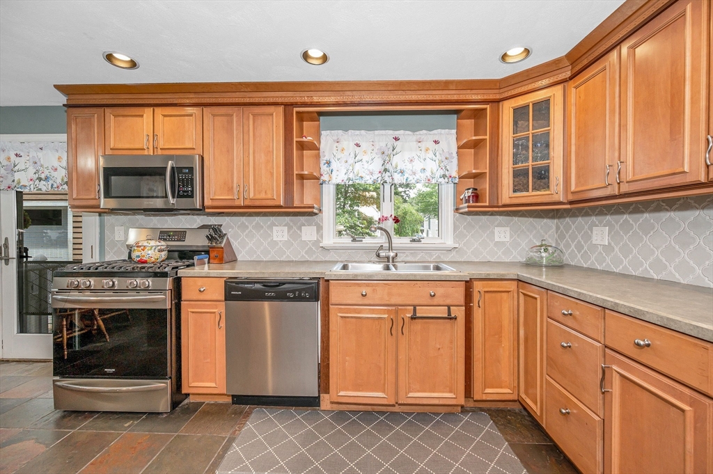 180 Foster Road Tewksbury, MA 01876 - Photo 11 of 38 a kitchen with stainless steel appliances granite countertop a stove and cabinets