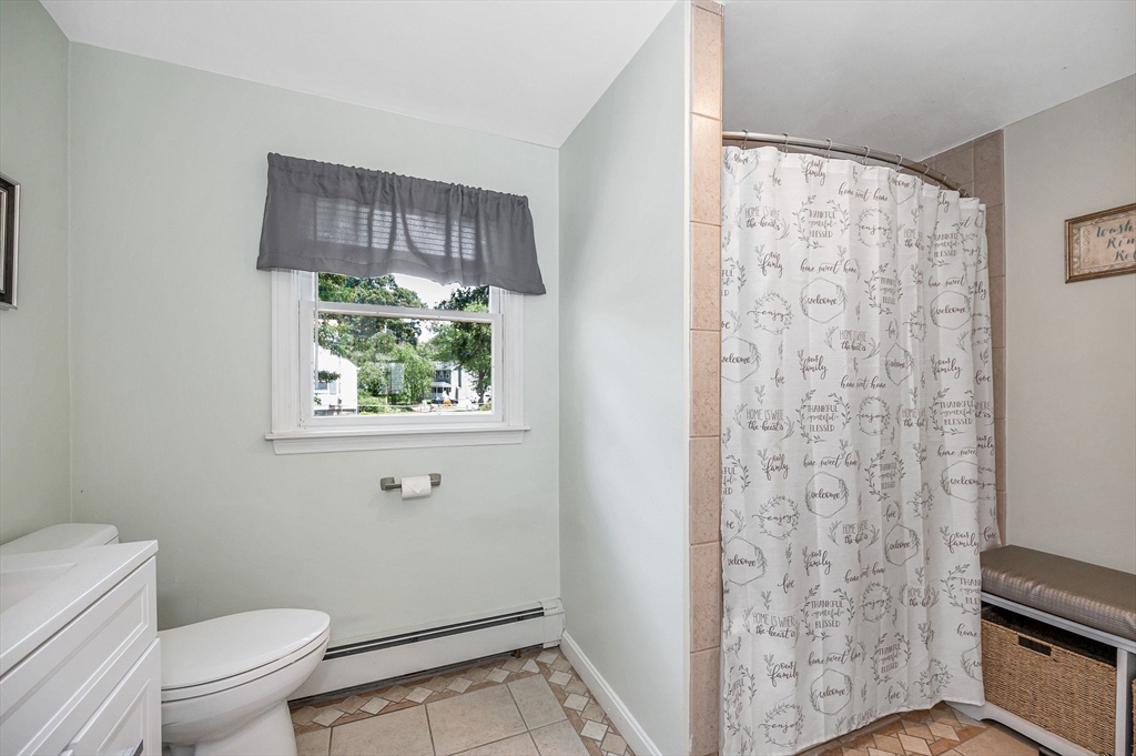 180 Foster Road Tewksbury, MA 01876 - Photo 12 of 38 a bathroom with a toilet and a shower curtain