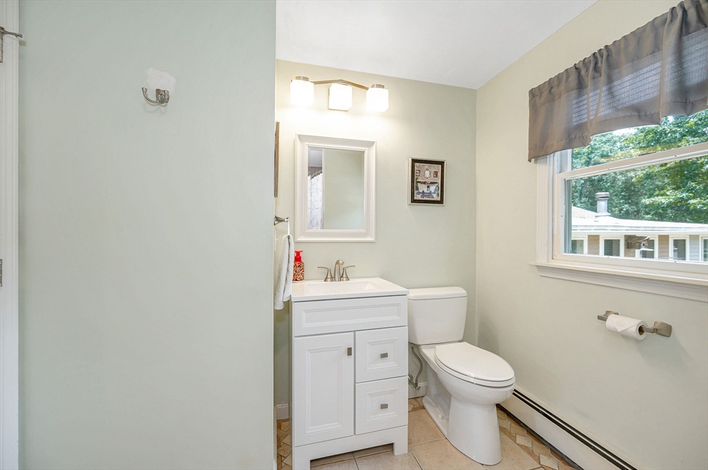 180 Foster Road Tewksbury, MA 01876 - Photo 13 of 38 a bathroom with a toilet a sink a vanity and mirror