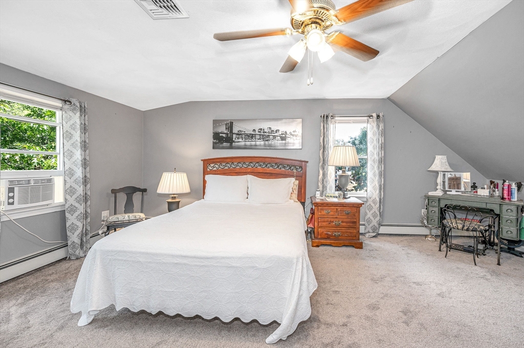 180 Foster Road Tewksbury, MA 01876 - Photo 16 of 38 a bedroom with a bed and a chandelier