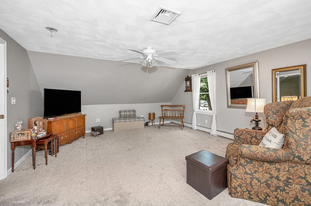 180 Foster Road Tewksbury, MA 01876 - Photo 22 of 38 a living room with furniture and a flat screen tv
