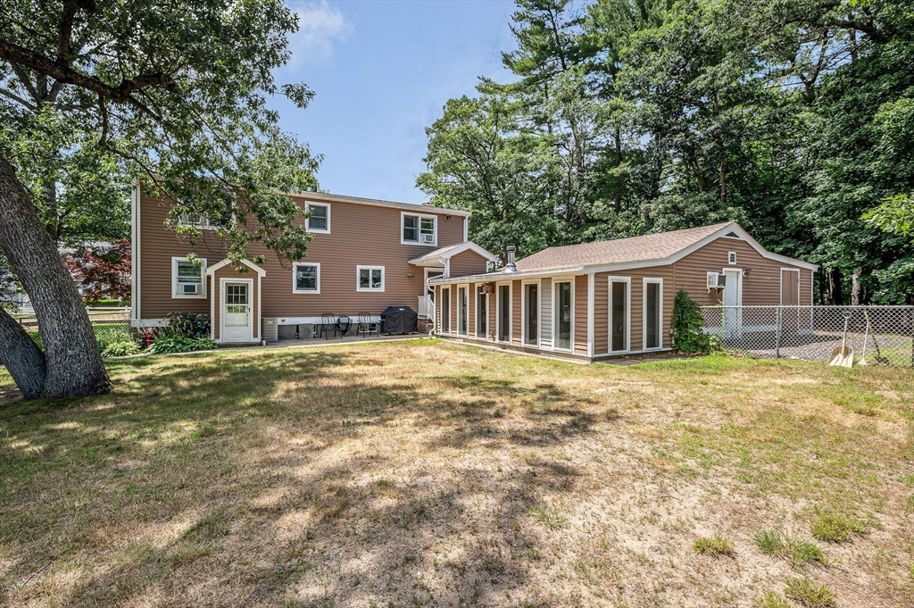 180 Foster Road Tewksbury, MA 01876 - Photo 31 of 38 a backyard of a house with table and chairs