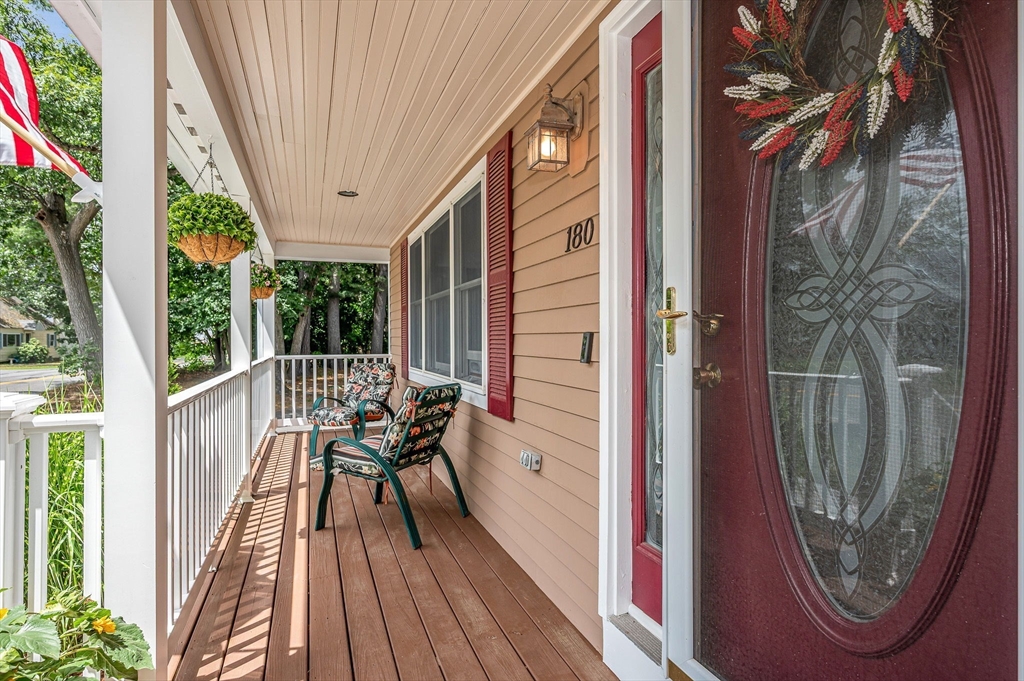 180 Foster Road Tewksbury, MA 01876 - Photo 34 of 38 a view of a balcony with chairs and wooden floor