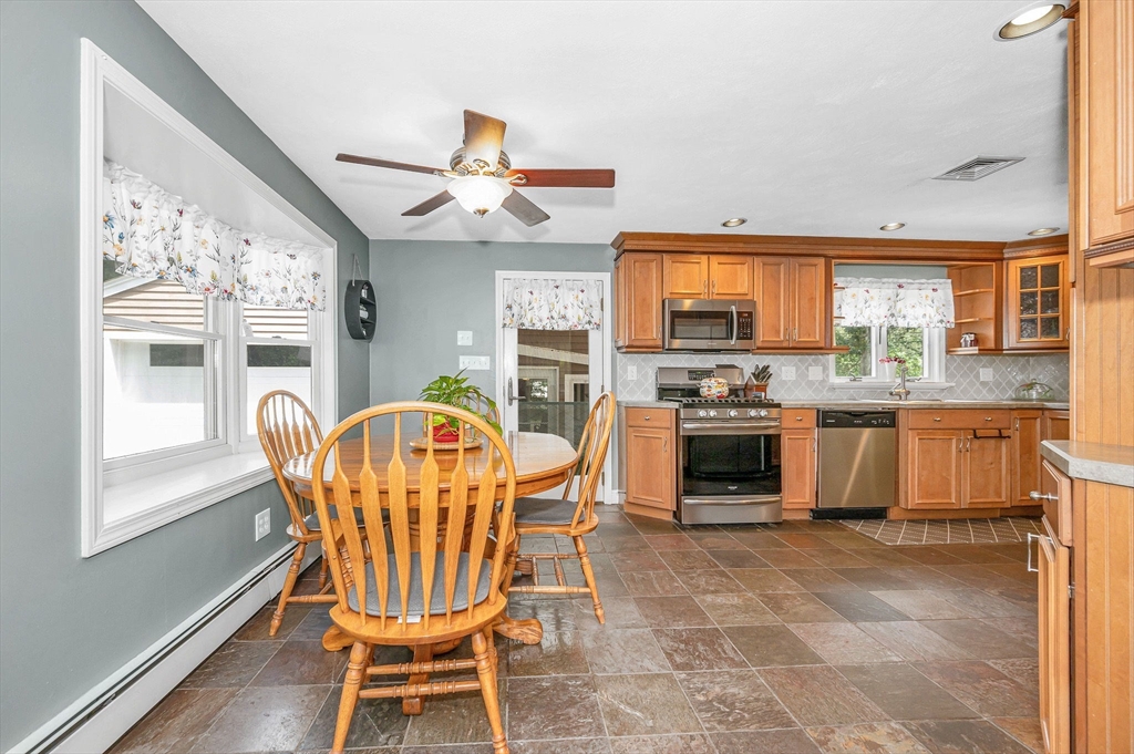180 Foster Road Tewksbury, MA 01876 - Photo 6 of 38 a kitchen with stainless steel appliances granite countertop a stove a refrigerator a kitchen island a table and chairs