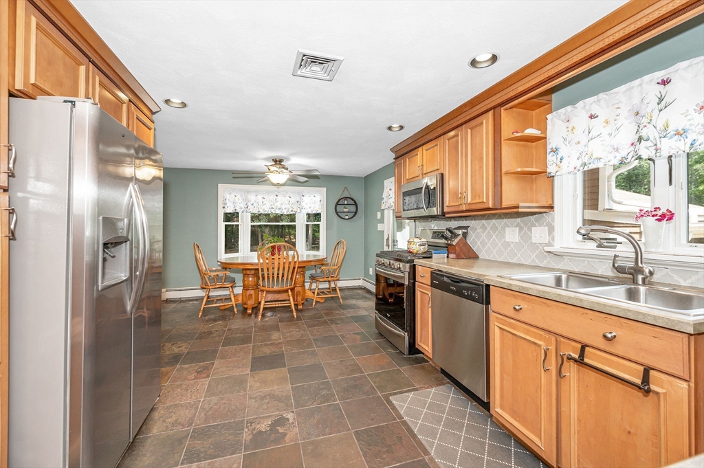 180 Foster Road Tewksbury, MA 01876 - Photo 10 of 38 a large white kitchen with a large window