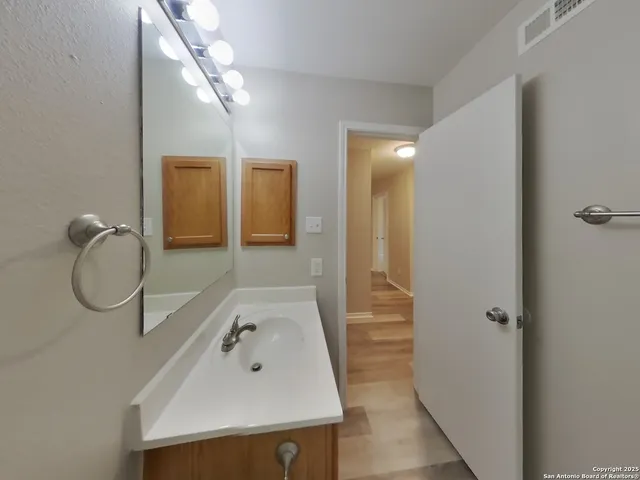 a bathroom with a sink and a mirror
