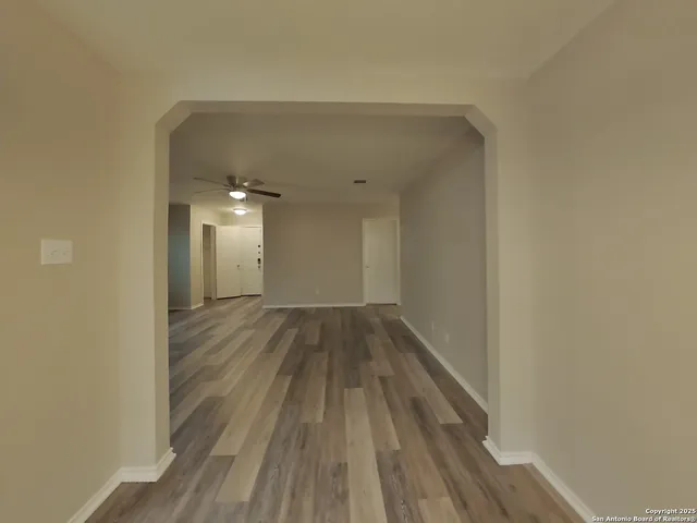 a view of a room with wooden floor
