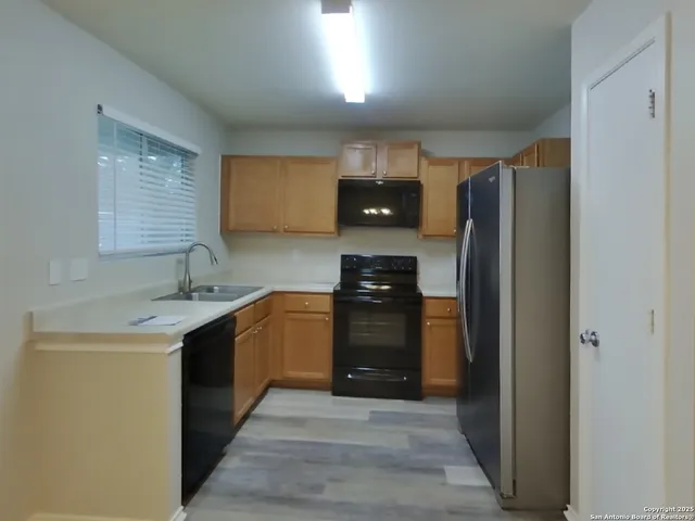 a kitchen with a refrigerator and a sink