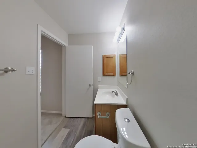 a bathroom with a toilet sink and mirror