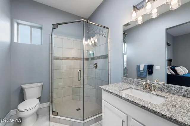 a bathroom with a granite countertop sink toilet and shower