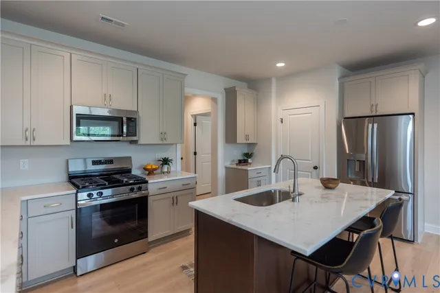 a kitchen with a stove a sink and a refrigerator