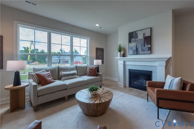 a living room with furniture a window and a fireplace