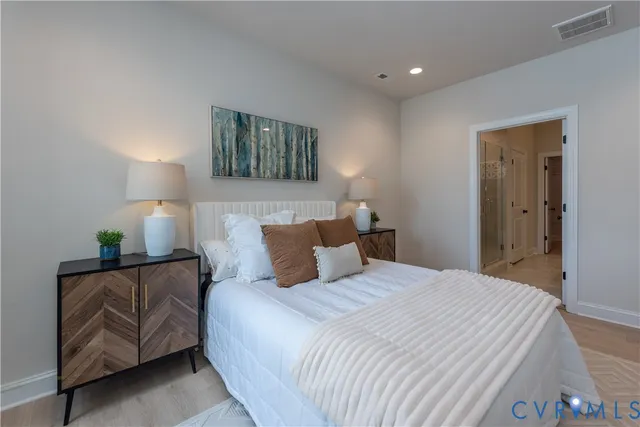 a bedroom with a bed and a lamp