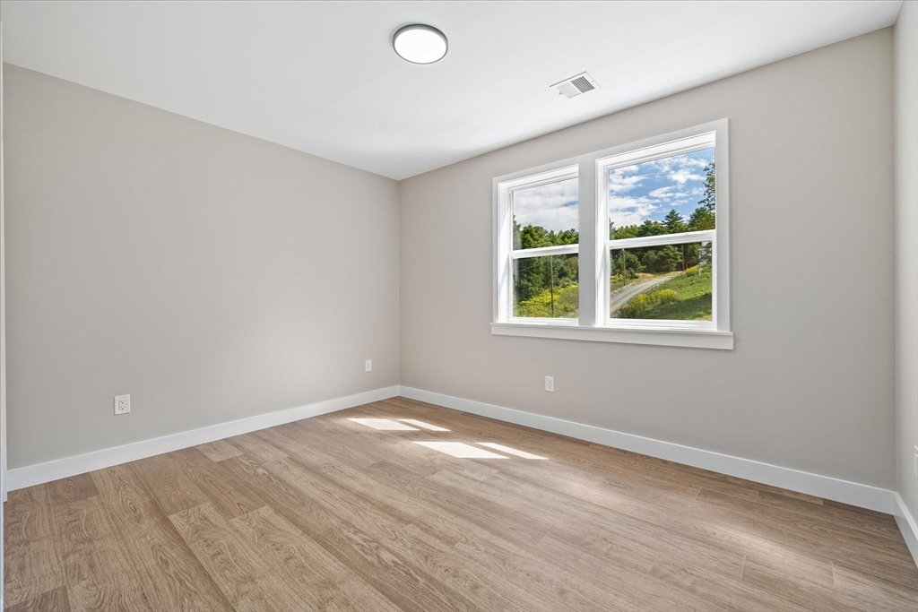 6 Eagleton Street Spencer, MA 01562 - Photo 27 of 36 an empty room with wooden floor and windows