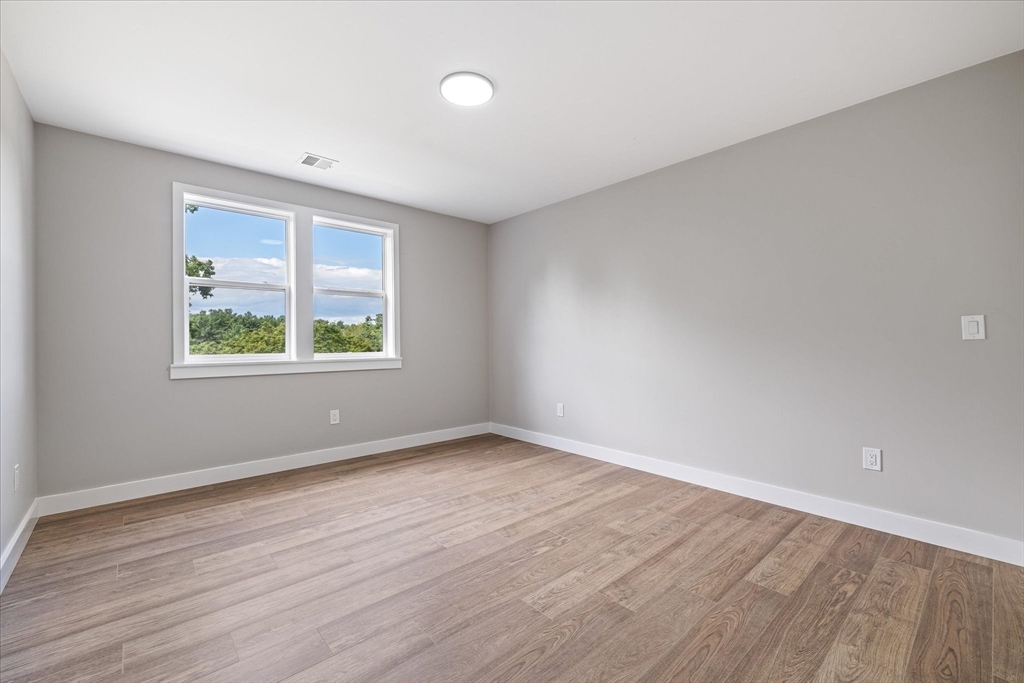 6 Eagleton Street Spencer, MA 01562 - Photo 29 of 36 an empty room with wooden floor and windows
