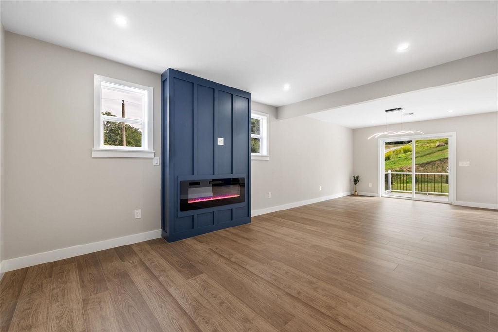 6 Eagleton Street Spencer, MA 01562 - Photo 4 of 36 a view of an empty room with a window and wooden floor