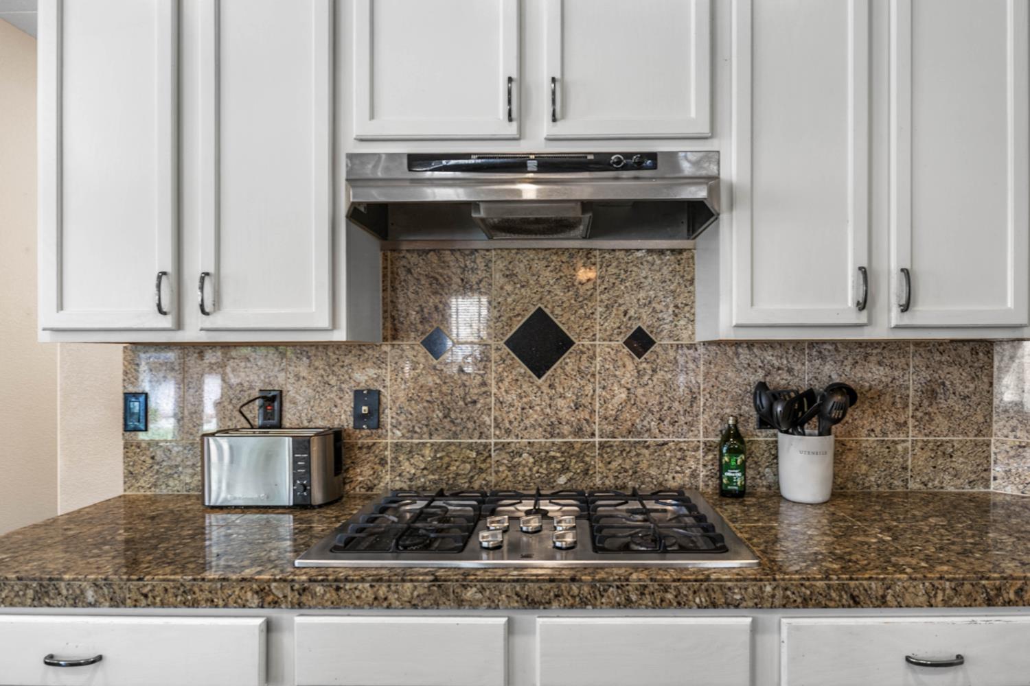 1777 Daniel Drive Ripon, CA 95366 - Photo 17 of 44 a kitchen with a stove and cabinets