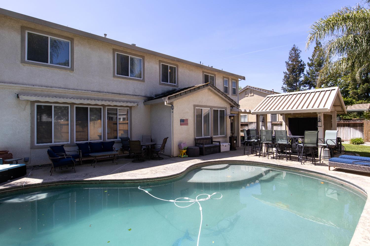 1777 Daniel Drive Ripon, CA 95366 - Photo 3 of 44 a view of a patio with swimming pool table and chairs