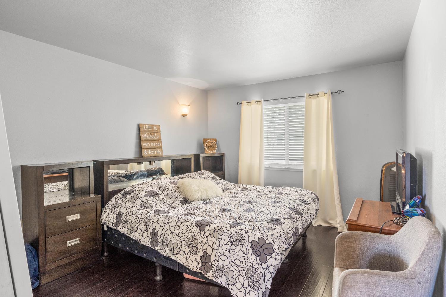 1777 Daniel Drive Ripon, CA 95366 - Photo 34 of 44 a bedroom with a bed and wooden floor