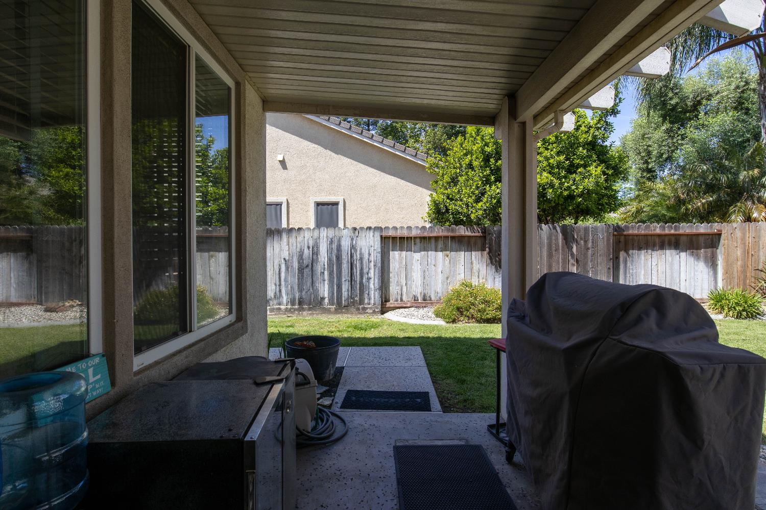 1777 Daniel Drive Ripon, CA 95366 - Photo 40 of 44 a view of a patio with table and chairs potted plants with floor to ceiling window