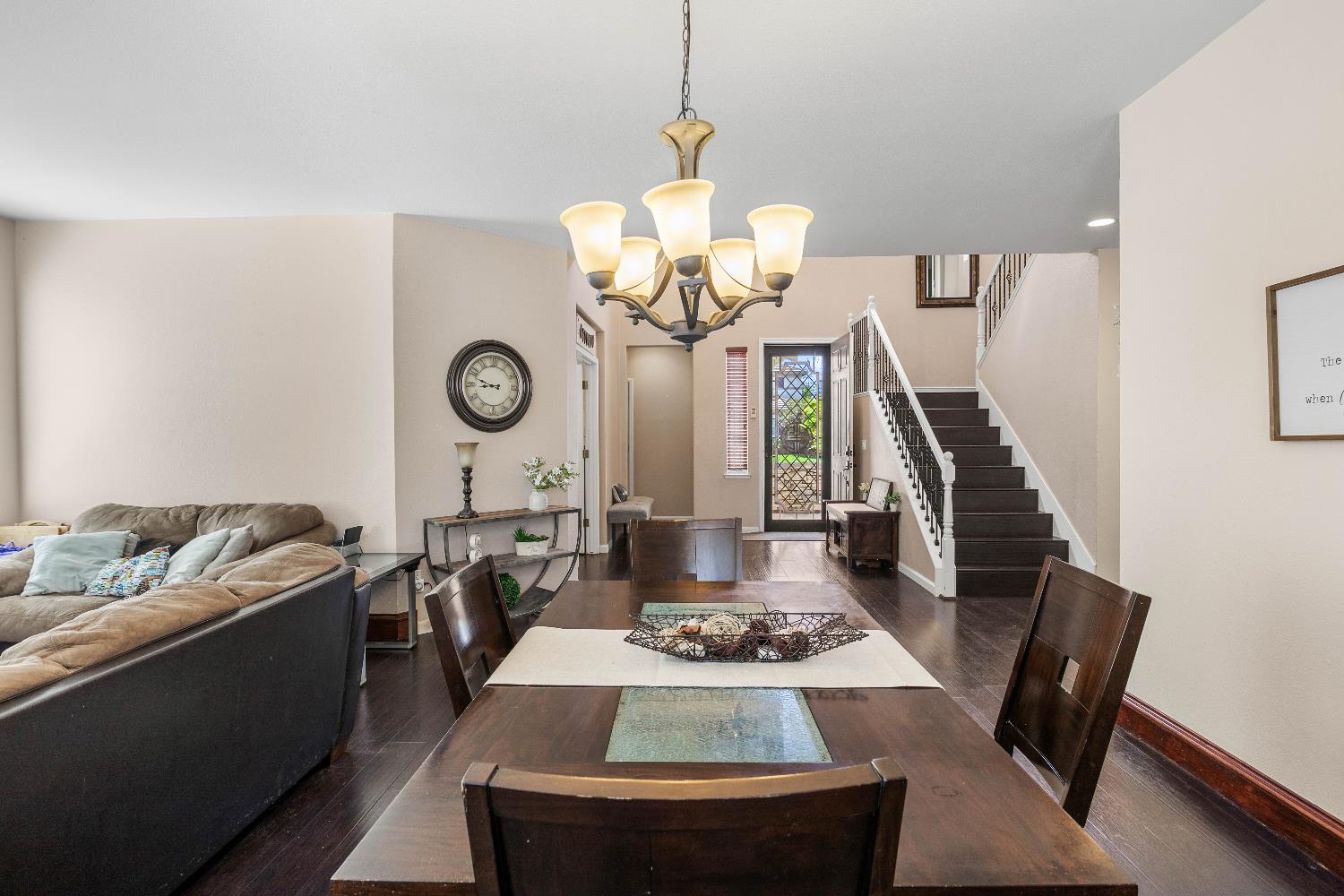 1777 Daniel Drive Ripon, CA 95366 - Photo 9 of 44 a view of a dining room with furniture a chandelier and wooden floor